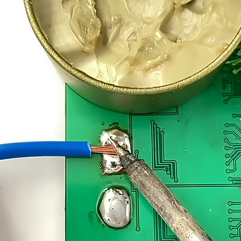 Soldering a blue wire onto a green circuit board with a soldering iron.