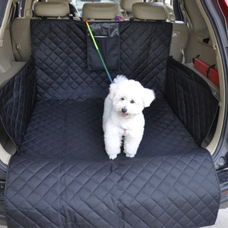 White dog on a black quilted car seat cover inside a vehicle